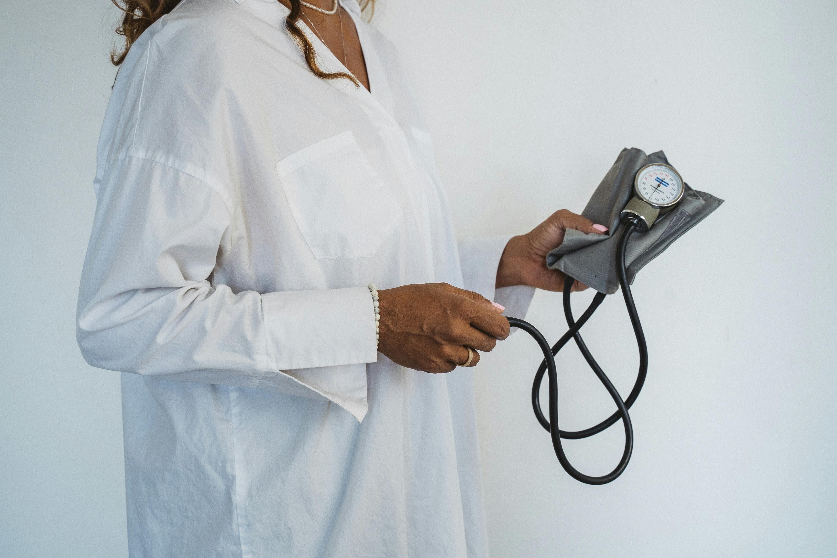 Woman checking her blood pressure at home between doctor visits