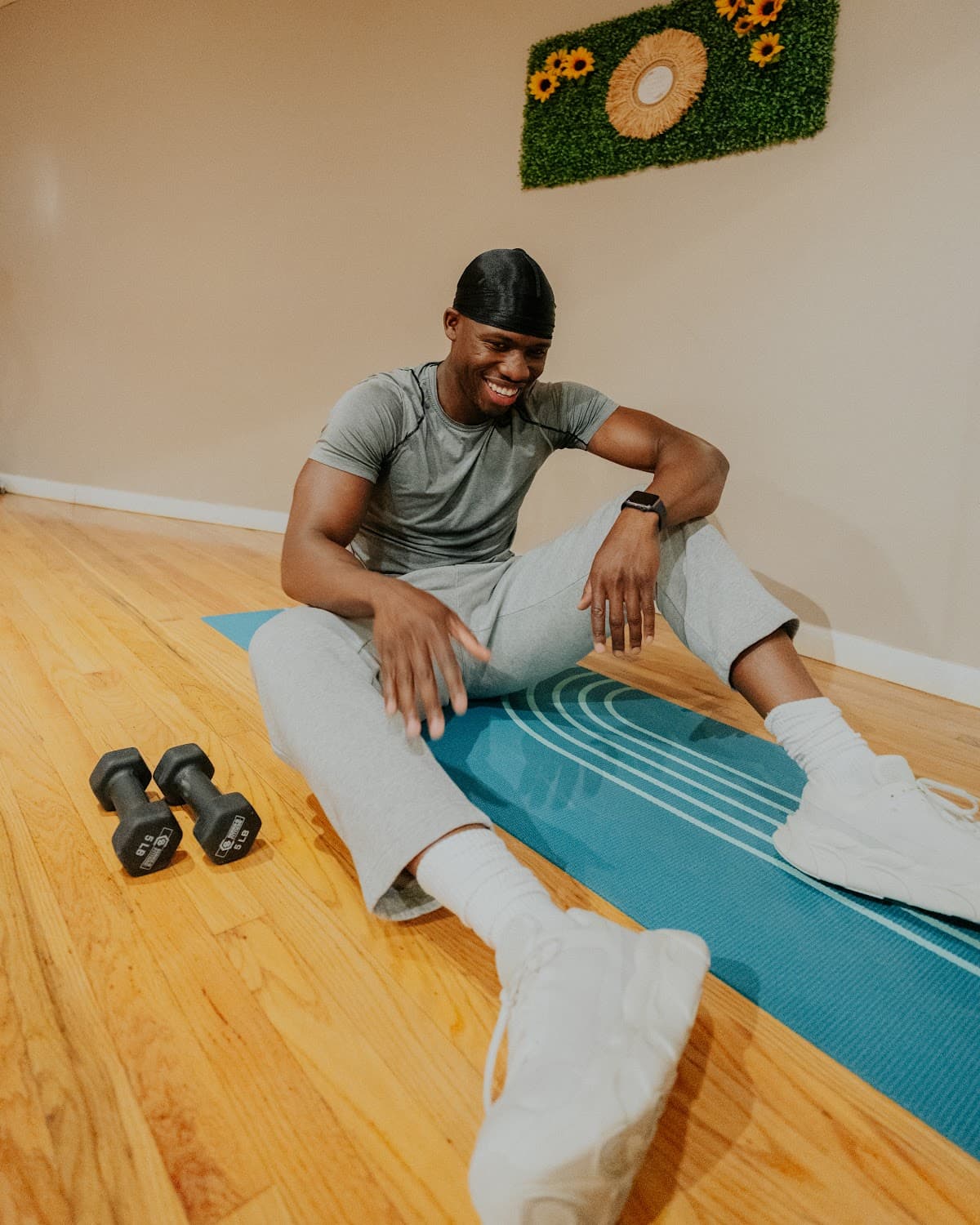 A Shape Health member smiling on an exercise mat